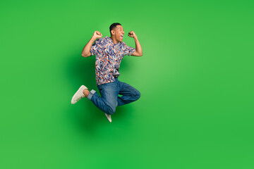 Full length photo of overjoyed cheerful man dressed summer outfit celebrate winning lottery jackpot isolated on green color background