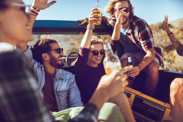Friends enjoying a road trip with drinks and laughter