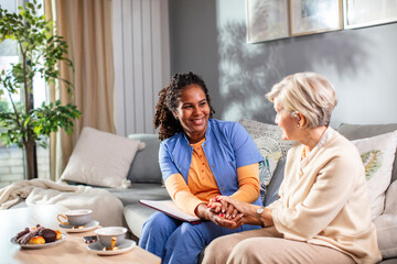 Senior woman talking to caregiver at home