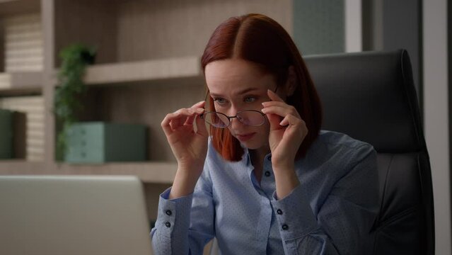 Caucasian businesswoman in office work with computer laptop confused with blurry vision business woman female worker manager off glasses check optical lenses problem bad eyesight focused see focusing