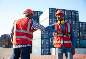 African factory workers or engineer greeting with elbow bumps in containers warehouse storage