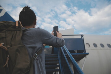 Happy attractive asian woman traveler with backpack at the modern airport terminal, copy space,...