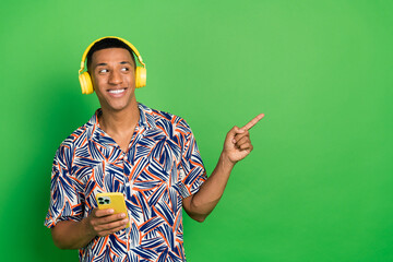 Photo of positive guy model listening bluetooth wireless device empty space sale discount modern...