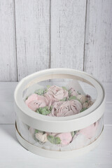 Marshmallow flowers. Homemade marshmallows. A box with transparent walls and a lid. The box is closed.