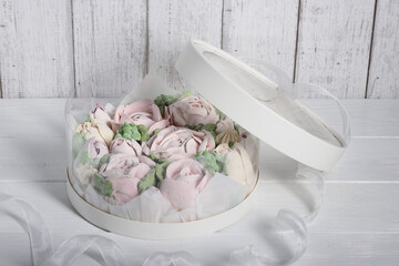 Fototapeta na wymiar Marshmallows in hatboxes. Marshmallow flowers. Homemade marshmallows. A white hatbox. A box with transparent walls and a lid.