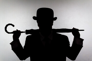 Silhouette of English Gentleman in Bowler Hat Holding Umbrella Like a Weapon. Vintage British Spy Hero and Crime Fighter.