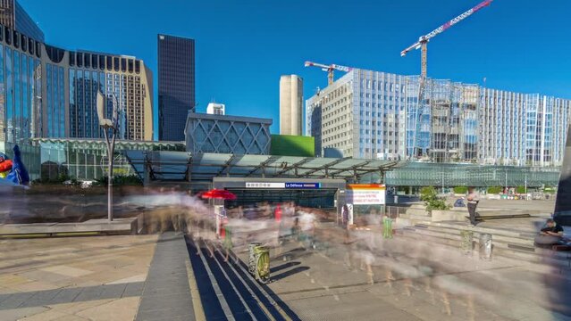 Panorama of La Defence timelapse hyperlapse, business and financial district with cranes over highrise skyscrapers buildings in the exit from metro station