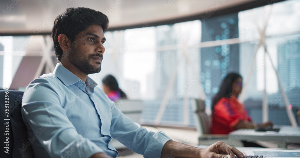 Poster close-up of a young indian male professional working in a business research and development company.