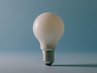 White Lightbulb on Grey Surface Blue Background