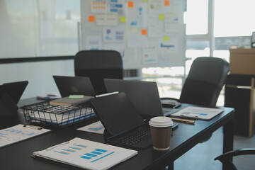 Laptop on a desk in an open financial office.