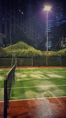Tennis court with a net and a racket at night