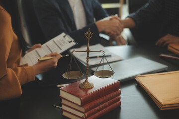 Justice and Law concept. Legal counsel presents to the client a signed contract with gavel and...