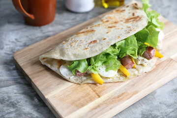 Italian cuisine , Piadina with sausage and cheese