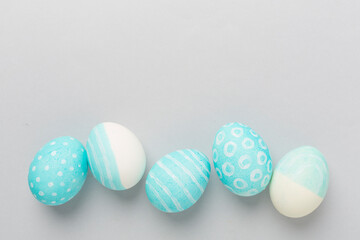 Blue easter eggs on color background, top view