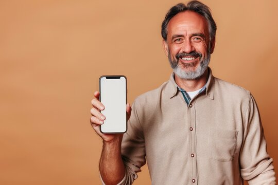Middle-aged man showing a phone with a blank screen to the camera, beige background
