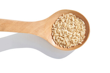 A closeup of long, uncooked brown rice grains on a wooden spoon surface, emphasizing the healthy, natural aspect of this whole food. Pile gluten texture