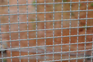 metal fence separating the border and the brick wall of the penitentiary out of focus