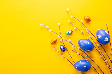 Blue Easter eggs on yellow background. Greetings card, Happy Easters. Flat lay ,top view