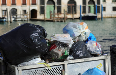 solid waste garbage bags in an overloaded dumpster in the city