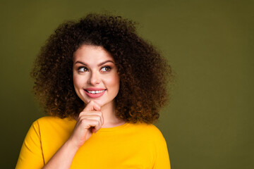 Fototapeta na wymiar Portrait of beautiful funky girl toothy beaming smile touch chin look empty space creative weekend time isolated on khaki color background