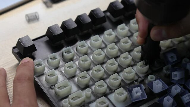 Man hand are cleaning of the computer keyboard on table