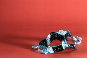 Venetian carnival mask, forming frame in one of the lower corners with space for text