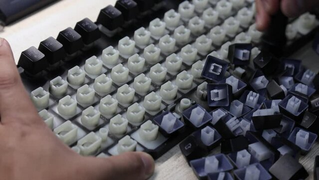 Man hand are cleaning of the computer keyboard on table