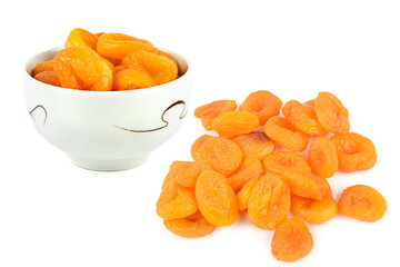 Dried apricots in a porcelain cup isolated on a white. There is free space for text. Collage.