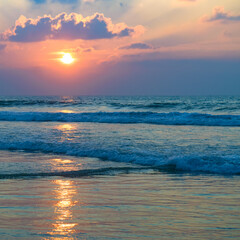Naklejka na ściany i meble Bright sunrise over the tropical sea. Vertical photo