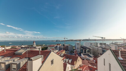 Panorama showing red roofs timelapse and 25 de Abril Bridge, Iconic suspension bridge over Tagus...