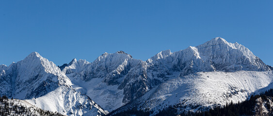 Stunning view of Tatra Mountains with snow and blue sky. 