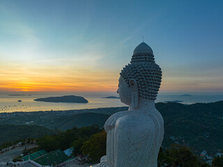 .aerial view scenery yellow sky glare of sun above Phuket big Buddha.Phuket Big Buddha is one of the island most important and revered landmarks on the island..image for travel and culture concept. © Narong Niemhom
