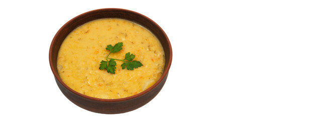 pea soup with a sprig of parsley in a clay plate	