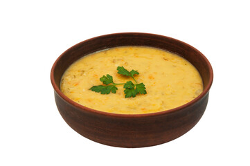 pea soup with a sprig of parsley in a clay plate	