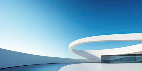 Modern curved building space with light and shadow under blue sky.