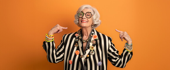 Joyful Silver-Haired Grandmother in Bold Striped Blazer Adorned with Eclectic Brooches – Radiant Charm Against a Sunset Orange Backdrop