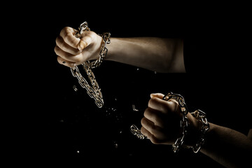 Hands breaking chains. Metal or steel chain is blown to pieces. Break free.