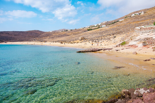Paralia Agios Sostis wild and free beach in the north of Mykonos, Greece. Pristine bay with blue sea and crystal water, famous for naturism and Kiki's Tavern, peaceful and quiet.
