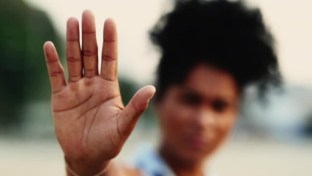 Firm Young Female of African Descent Showing STOP Hand Gesture, Serious Rejection Expression