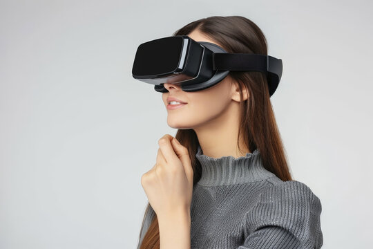happy gorgeous very attractive model girl, looking to his left, with a virtual reality viewer, the image has a minimalist white background