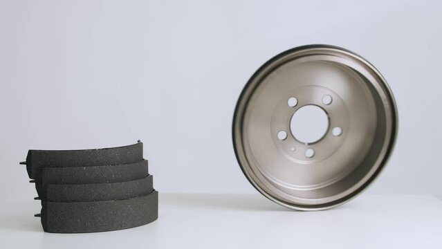 The best auto parts. Auto parts on a white background. Auto parts market. 
brake drum spinning on the table
