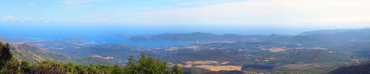 Fototapeta na wymiar panoramic view of the eastern coast of Corsica, nicknamed the Isle of Beauty, from the charming belvedere village of Prunelli. We see a large part of the plain, the island of Elba and Montecristo.