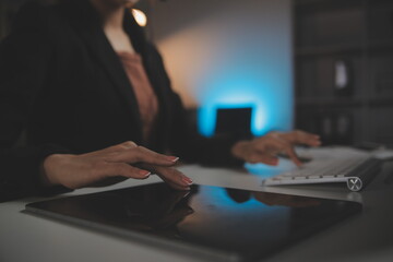 Young woman working in call centre, surrounded by colleagues