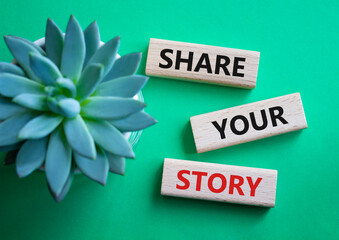Share your story symbol. Wooden blocks with words Share your story. Beautiful green background....