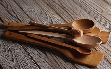 Set of different wooden spoons on wooden background