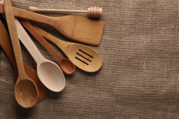 Wooden kitchen utensils on a sackcloth background