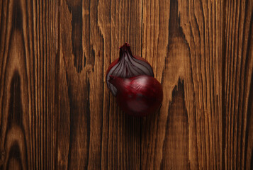 Red onion on a wooden background. Top view