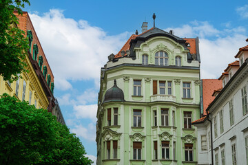 Historic low rise buildings with vivid colors against a blue sky with clouds at the city center of Bratislava, Slovakia.