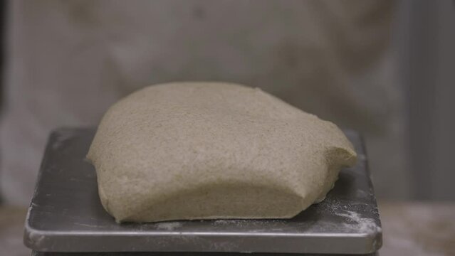 making bread, baker rationing bread dough