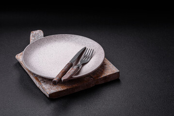 Cutlery fork, knife and spoon on a dark textured concrete background - 753210776